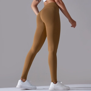 Detail view of high waist seamless yoga pants with peach lift and caramel ribbing