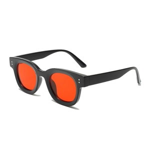 Retro oval sunglasses with thick black frame, orange lenses and silver rivets detail