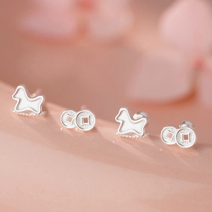 Macro shot of S999 sterling silver knot earrings and rocking horse studs set