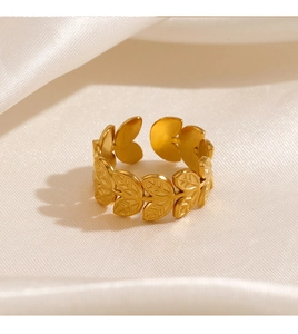 Detailed close-up of golden leaf pattern texture on adjustable steel ring
