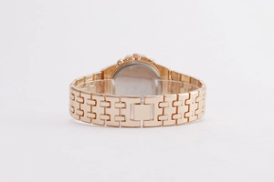 Macro view of rose gold metal strap and back structure of a diamond studded men's watch
