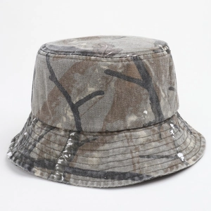 Close-up of washed camouflage bucket hat with white paint splatters and stitched brim