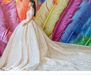 Detail of off-the-shoulder bridal gown with luxury sequin embroidery and long royal train