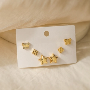 Set of 18K gold plated butterfly, rhombus and star stud earrings on a jewelry card