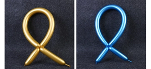 Detail of metallic gold and blue twistable long balloons with glossy reflective texture