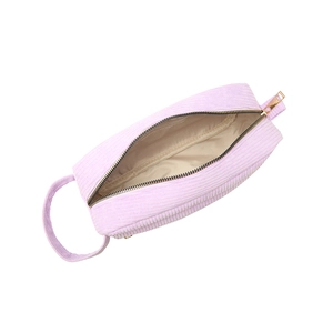 Portable lavender corduroy cosmetic bag with gold zipper and handle on white background