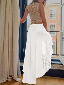 Detail of elegant white satin midi skirt featuring delicate lace patchwork and texture