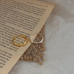 Minimalist S925 sterling silver twisted open rings in gold and silver on vintage pages