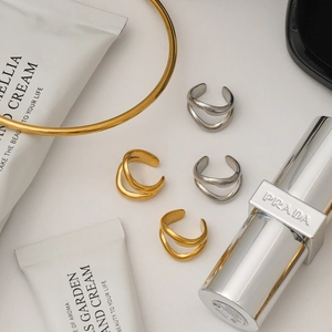 Minimalist 18K gold and silver stainless steel rings and choker on a clean white background