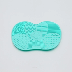 Detail of teal silicone makeup brush cleaner mat with various cleaning textures and patterns