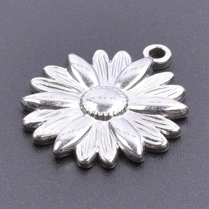 Macro shot of silver stainless steel sunflower pendant with detailed metal petals