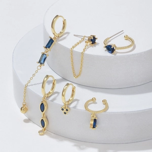 Luxurious gold drop earrings set with deep blue zircon stones and elegant tassel chains