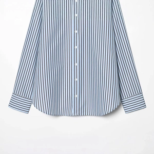 Light blue striped poplin shirt with long sleeves and curved hem in a flat lay view