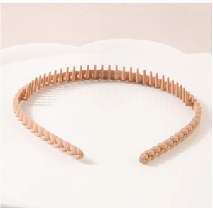 Detail of nude matte headband with woven texture and non-slip inner teeth for secure hair grip