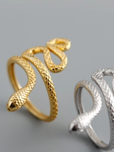Detailed close-up of adjustable snake rings in gold and silver showing realistic scale textures