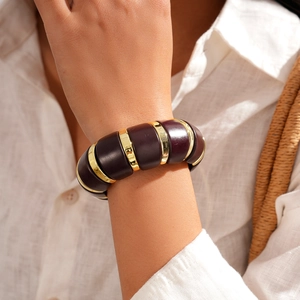 Detail of vintage acrylic oval stretch bracelet with gold metal spacer rings on wrist