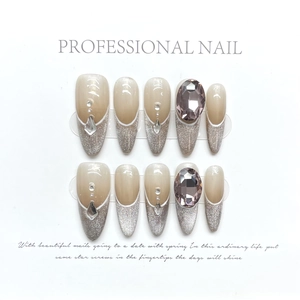 Handmade cat-eye press-on nails with silver glitter gradient and rhinestones