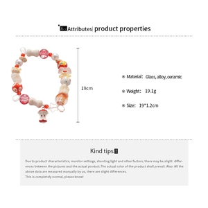Detailed view of ceramic beaded bracelet with apple charms and size measurements