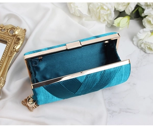 Detail of satin evening clutch interior with golden hardware in elegant lake blue