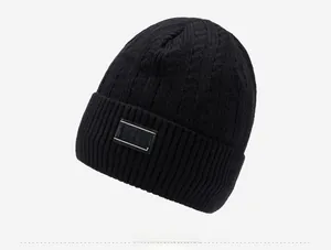 Detailed close-up of black knitted beanie featuring cable texture and IFARDI woven label