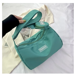 Green nylon crescent tote bag with wide shoulder strap and small round coin pouch detail