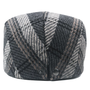 Close-up of thick checkered tweed fabric and rear metal snap buttons on a flat cap