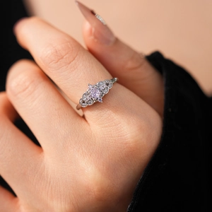 Detailed close-up of a vintage silver crown ring with lavender zircon and side diamonds