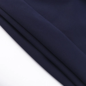 Macro shot of dark blue knit fabric texture showing smooth weave and soft folds
