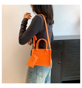Detail of orange crocodile pattern handbag set with detachable coin purse and shoulder strap