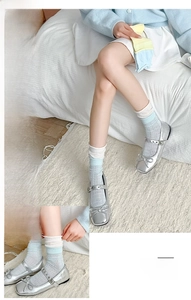 Detail of Korean style cream contrast crew socks paired with silver Mary Jane shoes