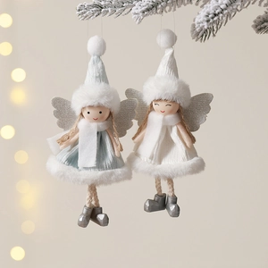 Plush Christmas angel dolls with knit hats and silver wings hanging on pine branches