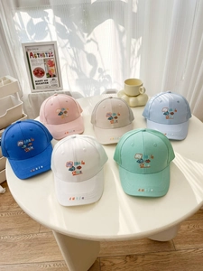 Close-up of children's mesh sun hats with My Little Cutie embroidery in six pastel colors