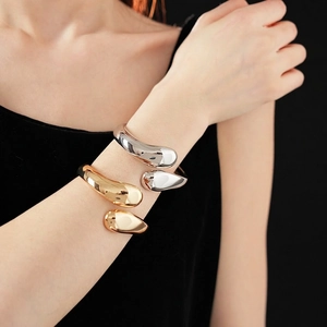 Polished silver and gold metal waterdrop open bracelets with a liquid organic design