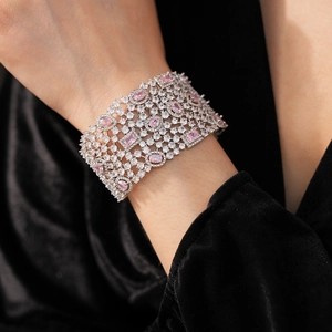 Close-up of wide silver bangle with sparkling pink and white cubic zirconia crystals