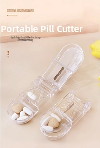 Close-up of portable pill cutter box with stainless steel blade and pill storage compartments