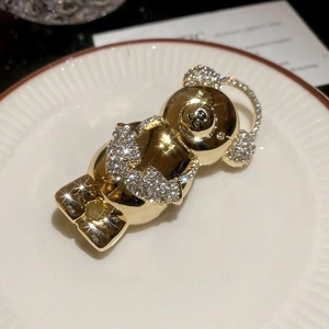 Macro detail of luxury gold-plated bear brooch with sparkling crystal rhinestones