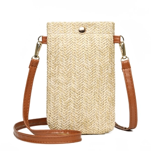 Vertical straw woven crossbody phone bag with red leather strap and gold buckle