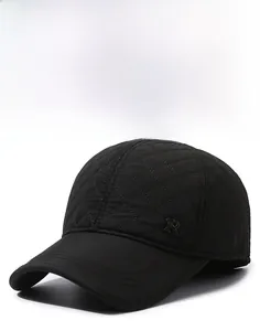 Detail of black winter baseball cap with diamond quilted fabric and metal R logo