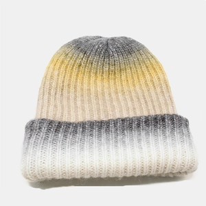 Detail of chunky ribbed knit texture on a gradient tie-dye beanie hat for winter warmth