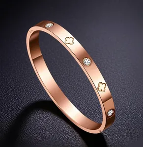 Detail von Roségold Kleeblatt Armband mit Steinen auf dunklem Leder Hintergrund