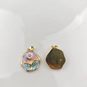 Detail view of double-sided enamel flower pendant with gold frame and oil painting style
