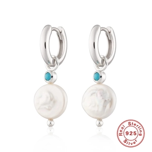Detail of 925 sterling silver hoop earrings with turquoise and baroque pearls