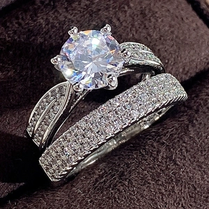 Luxury silver bridal ring set featuring a classic six-prong solitaire and pavé wedding band