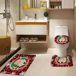 Detailed view of red and black plaid Christmas bathroom mats with Santa Claus pattern