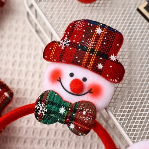 Detail of Christmas snowman headband with red plaid hat and glowing lights for party