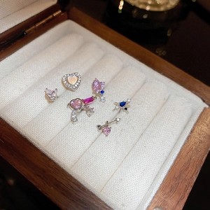 Detailed close-up of heart and butterfly stud earrings set with colorful zircons