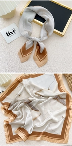 Close-up of geometric silk-like square scarf with coffee and beige abstract patterns