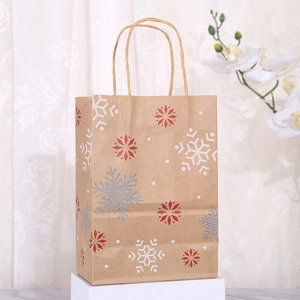 Brown Christmas kraft paper gift bag featuring red and white snowflake patterns