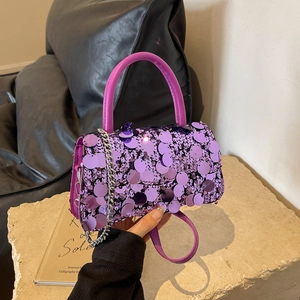 Detailed view of shimmering purple sequins and sleek leather handle on the small square bag