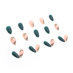 Almond press-on nails in deep green and nude pink with delicate black leaf patterns